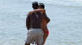 Young African American Couple By Edge Of Water At Ocean