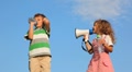 Girl Laughing Through Megaphone, Boy Drinking Water And Plugging Up Ear