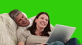 Elderly Couple Laughing In Front Of A Laptop