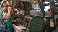 Senior Veiled Lady Operating Silk Weaving Machine Inside Silk Factory In Asia