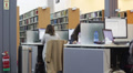 Library Workstations With Books In The Background