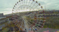 Ferris Wheel Spins Near Roller-Coaster Amusement