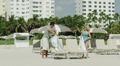 Ws Couple Relaxing On Deckchairs On Beach / South Beach, Miami, Florida, Usa
