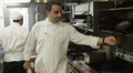 Slo Mo Ms Pan Chef Cooking In Commercial Kitchen / Miami, Florida, Usa