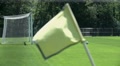Waving Corner Yellow Flag On Empty Soccer Field
