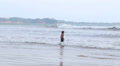 The View Of The Ocean In Weligama, Sri Lanka With A Kid Enjoying The Waves.