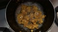 Gram Flour Fritters Being Deep Fried In A Wok In An Indian Domestic Kitchen