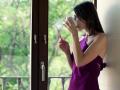Young, Pensive Woman Drinking Coffee And Looking By The Window Ntsc