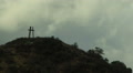 Time Lapse Of A Christian Holy Trinity Symbol On Hill Against A Blue Cloudy Sky