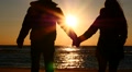 Man And Woman Slow Motion Towards To Sun And Sea Side.