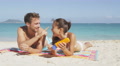 Beach Couple Having Fun Putting Sunscreen Suntan Lotion Laughing Relaxing