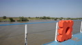 Life Buoy On Deck Of A Cruise Ship Sailing In Water Traveling Along River Banks