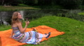 Woman Drink Cider Champagne Alcohol Sitting On Plaid Near River