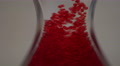 Red Bubbles Moving Upwards Through Hourglass