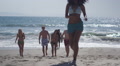 Authentic Young Group Of Interracial Friends Walking To The Beach Shore