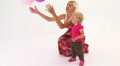 Mother And Baby Girl Playing With Bunch Of Multi-Colored Balloons