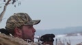 Hunter Blowing Duck Call From Hunting Blind