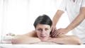 Masseur Giving Massage To Tired Adult Woman In Spa Salon