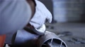 Man With Protective Gloves Using Angle Grinder On Steel