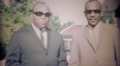 1969: African Men Wearing Sunglasses Enter Long White Lincoln Car.