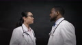 4k Portrait Of Doctors In White Coats, Standing In Front Of Blank Blackboard