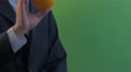 Man Is Holding An Orange Shows The Fruit Takes Away On A Green Screen Young