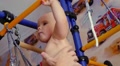 Child Is Engaged In A Sports Training Apparatus At Home And Dad Take His Baby On