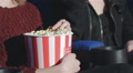 Close Up Hand Holding A Bucket Of Popcorn