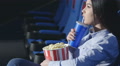 Asian Girl In Profile Drinking Soda In A Cinema