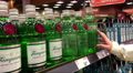 A Hand Takes Bottle Of Uk Tanqueray No Ten Batch Distilled From The Shelf