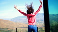 Excited Woman Jumping On Terrace