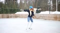 Happy Teenager Girl Graceful Skates And Spins At Ice Rink At Winter