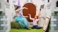 Happy Woman And Girl Play In Room With Cardboard Castle