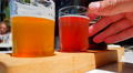 4k Hand On Glass, Craft Beer Tasting Samples On Outside Table At Pub