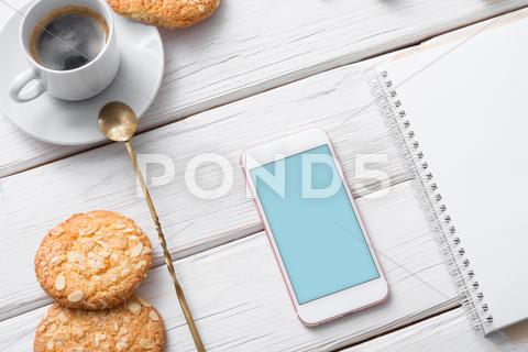 White Smart Phone Mock Up Over Cafe Table. Clipping Path Included