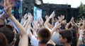 People Crowd Young Fans Jumping Raise Hands Up In Front Of Music Concert Stage