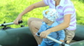 Beautiful Baby Boy Playing With An Inflatable Boat And A Paddle With Mother. The