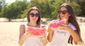 Two Pretty Girls Breaks Off A Piece Of Watermelon And Eating