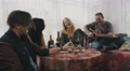 Friends In Country House At Table Drink Alcohol. Sing. Man Playing Guitar