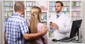 Couple In Pharmacy Store Medicine Product Presentation Pharmacist Man Talking