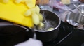 Cook Pours Potatoes In Boiling Water