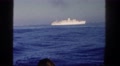 1962: Older Gentleman And Ladies On Boat Watching Cruise Ship Go By On The Water