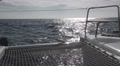 Pov Shot Looking Forward On Catamaran As It Cuts Through Waves Under Full Sai
