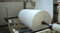 Pulp And Paper Plant. Sheet Of Paper Hanging. Big Roll Of White Paper At The