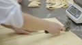 Hands Cutting Dough With A Knife. Process Of Cooking French Croissants