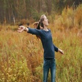 Beautiful Girl Dancing In The Autumn Forest. Girl Have Fun And Smiling