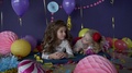 Two Pretty Baby Girls Sisters Kissing And Celebrating On Birthday Party