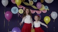 Two Baby Girls Sisters Waving And Celebrating On Birthday Party