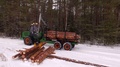 Forwarder Working In The Forest, Processing Wood In The Winter Forest