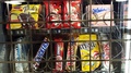 Snacks, Chocolates And Sweets Behind Vending Machine Bars